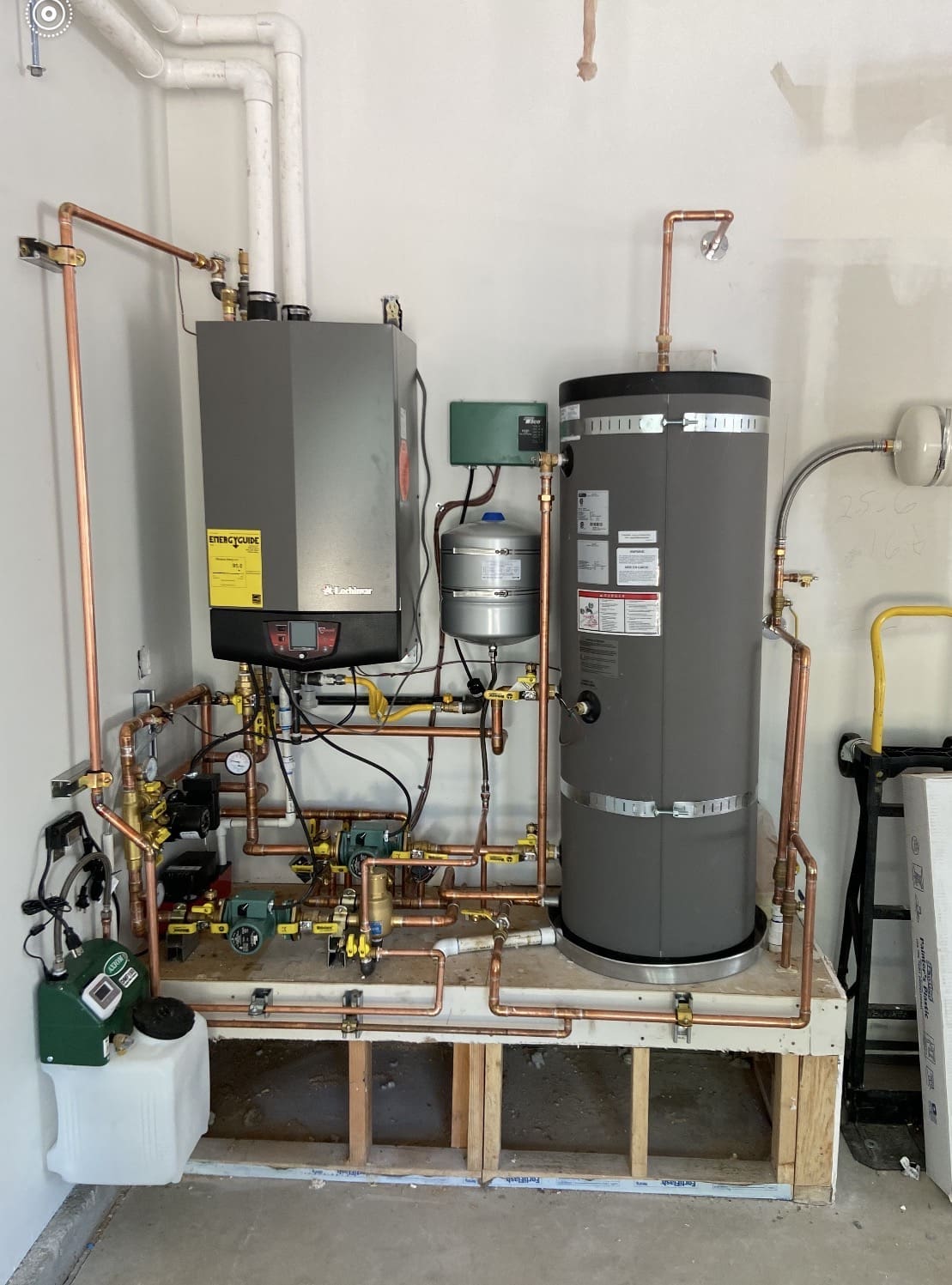 Technician performing maintenance and inspection on a residential boiler system.